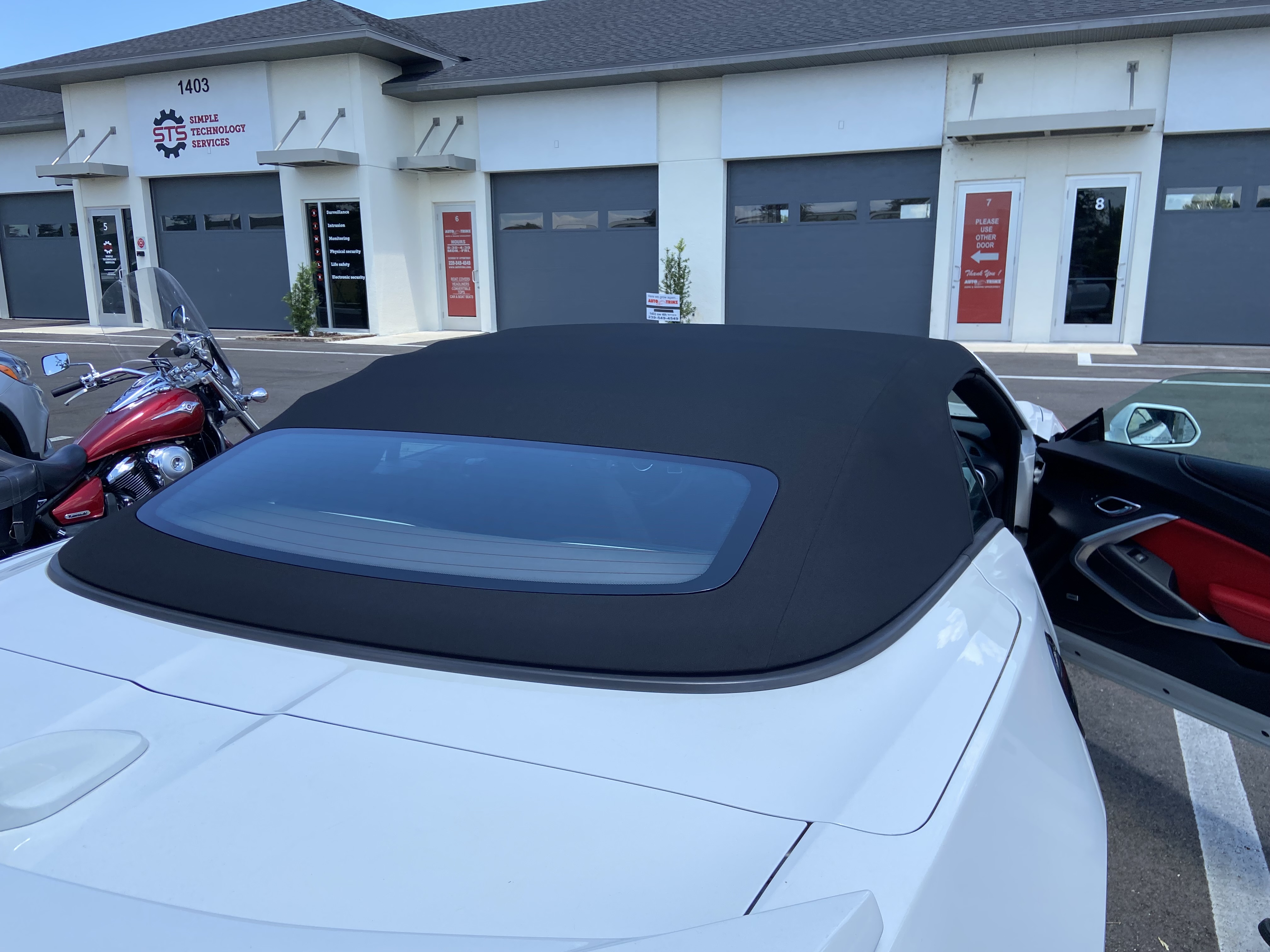 Sports Car Parked On The Outside of The Garage